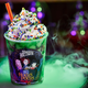 Milkshake in a Hocus Pocus promotional cup on top of a bubbling, steaming cauldron